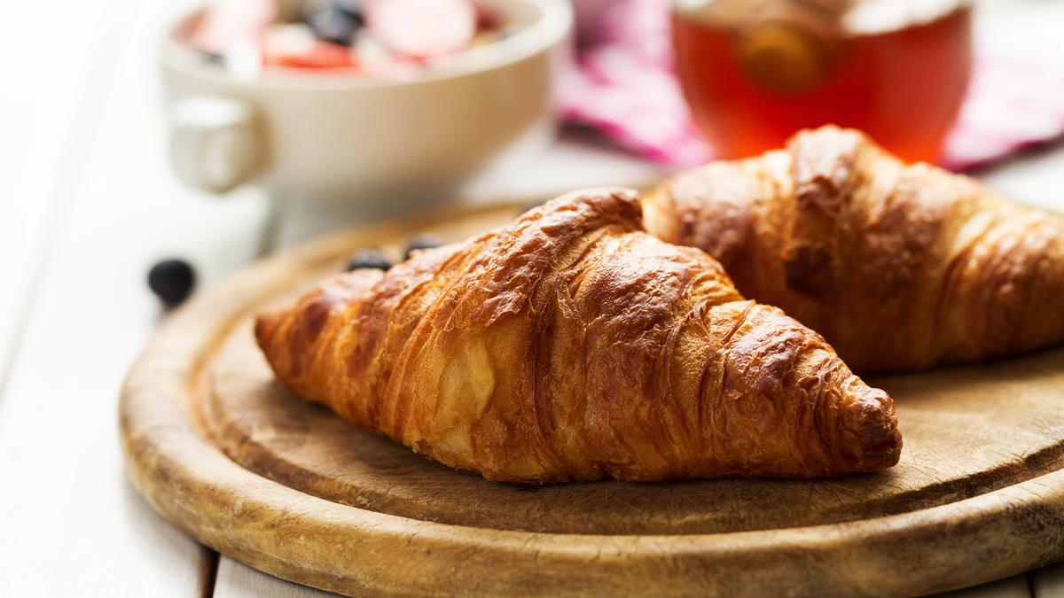 010116600_1742806632-tasty-beautiful-croissants-wooden-board-traditional-continental-breakfast-grano.jpeg